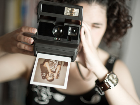 Girl taking an instant photo