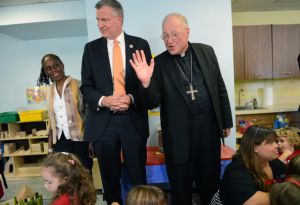 NEW YORK, NY - SEPTEMBER 4: New York Mayor Bill de Blasio and First Lady Chirlane McCray visit a Pre-K class on September 4, 2014 at Sacred Heart School in the Staten Island borough of New York City. New York Mayor Bill de Blasio is touring universal pre-kindergarten programs throughout the city. Also pictured (L-R) is First Lady Chirlane McCray, New York Mayor Bill de Blasio and Timothy Cardinal Dolan. (Photo by Susan Watts-Pool/Getty Images)