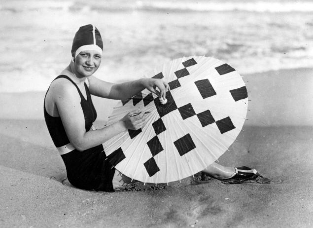 A model, circa 1925, creates a crossword design on her parasol in Palm Beach, Florida. (Photo: Getty Images)
