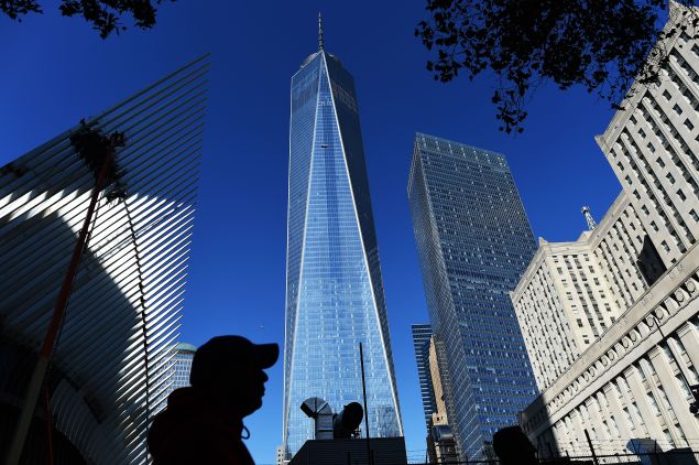 People walk past the construction site of the One World Trade Center in New York on October 17, 2014. US spending on construction slowed in August 2014, with declines in both the private and public sectors, the Commerce Department reported. Total construction spending fell 0.8 percent from July to an annual rate of $961.0 billion, but year-over-year was up 5.0 percent. The July figure was revised sharply lower to $968.8 billion from the prior estimate of $981.0 billion. AFP PHOTO/Jewel Samad (Photo credit should read JEWEL SAMAD/AFP/Getty Images)