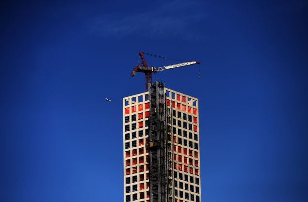 An passenger plane is seen flying past US tallest residential skyscraper in New York on January 9, 2015. AFP PHOTO/JEWEL SAMAD (Photo credit should read JEWEL SAMAD/AFP/Getty Images)