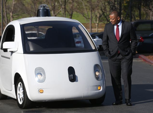 U.S. Transportation Secretary Anthony Foxx inspects a Google self-driving car. 