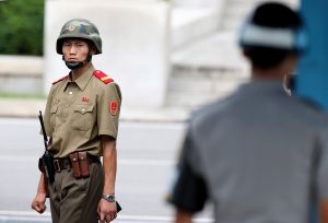 PANMUNJPM, SOUTH KOREA - JULY 27: A North Korean soldiers looks on as South Korean and United Nation officials visit after attending a ceremony to commemorate the 62nd Anniversary of the Korean War armistice agreement at Panmunjom on July 27, 2015, South Korea. On June 25, 1950, soldiers of the North Korean army breached the 38th parallel invading the Republic of South Korea, marking the beginning of the Korean War. On July 27 1953, a signed armistice agreement brought the three-year conflict to an end. (Photo by Jeon Heon-Kyun-Pool/Getty Images)