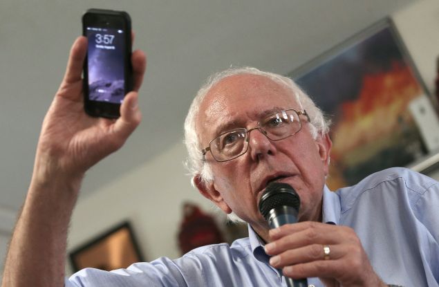 Can you hear me now? Democratic presidential candidate U.S. Sen. Bernie Sanders (I-VT) holds up his mobile phone while answering a question about privacy issues during a campaign event at the IAFF Local 809 Union Hall August 16, 2015 in Clinton, Iowa. Sanders was scheduled for a full day of campaigning in eastern Iowa today. (Photo by Win McNamee/Getty Images)