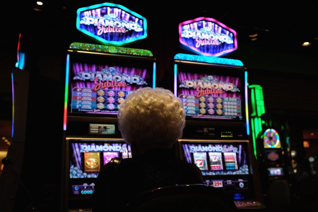 ATLANTIC CITY, NJ - AUGUST 29:  An elderly woman plays slot machines in a casino on the Atlantic City Boardwalk on August 29 in Atlantic City, New Jersey. After new casinos opened in neighboring states, four of the city's top casinos closed in 2014, laying-off some 8,000 workers. The closures brought Atlantic City's unemployment rate to more than 11 percent, double the national average. The mass unemployment has produced the highest foreclosure rate of any metropolitan U.S. area, with 1 out of 113 homes now in foreclosure in Atlantic County.  (Photo by John Moore/Getty Images)