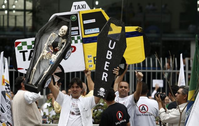 Taxi drivers demonstrate outside the chamber of deputies in the neighborhood of Se, Sao Paulo, Brazil, on September 9, 2015, against the use of the Uber application in the country. The demonstration was called by the Brazilian association of taxi unions. AFP PHOTO / Miguel SCHINCARIOL (Photo credit should read Miguel Schincariol/AFP/Getty Images)