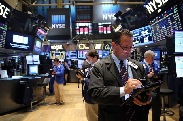 NEW YORK, NY - SEPTEMBER 11: Traders work on the floor of the New York Stock Exchange (NYSE) on September 11, 2015 in New York City. The Dow was down 50 points in morning trading. Throughout the nation people are holding somber gatherings and memorial events to reflect on the 14-year anniversary of the 9/11 attacks that resulted in the loss of nearly 3,000 people. (Photo by Spencer Platt/Getty Images)
