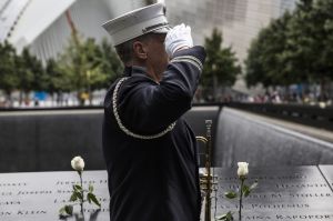NEW YORK, NY - SEPTEMBER 11: Captain Tom Engel of the New York Fire Department plays taps at the end of the ceremony commemorating the 14th anniversary of the September 11th terrorist attacks on September 11, 2015 in New York City. Today marks the 14th anniversary of the attacks where nearly 3,000 people were killed in New York, Washington D.C. and Pennsylvania. (Photo by Andrew Burton/Getty Images)