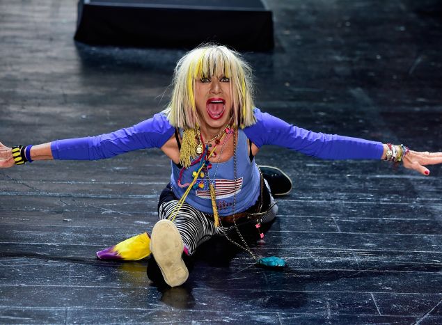 Betsey Johnson does her signature gymnastics routine at the end of her NYFW runway show. (Photo: Getty Images)