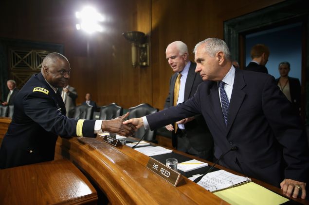 WASHINGTON, DC - SEPTEMBER 16: Gen. Lloyd Austin III (L), commander of U.S. Central Command, greets Senate Armed Services Committee ranking member Sen. Jack Reed (D-RI) (R) and Chairman John McCain (R-AZ) before a hearing about the ongoing U.S. military operations to counter the Islamic State in Iraq and the Levant (ISIL) during a hearing in the Dirksen Senate Office Building on Capitol Hill September 16, 2015 in Washington, DC. Austin said that slow progress was still being made against ISIL but there have been setbacks, including the ambush of U.S.-trained fighters in Syria and the buildup of Russian forces in the country. (Photo by Chip Somodevilla/Getty Images)