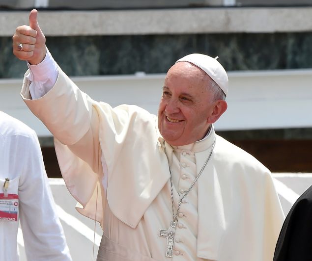Pope Francis (C) gives the thumbs up at faithful at the end of an open mass celebrated at Calixto Garcia Square in Holguin, eastern Cuba, on September 21, 2015. Holguin, a cradle of Catholic faith on the island and also the home region of communist leaders Fidel and Raul Castro, is the only stop on the pope's eight-day, six-city tour of Cuba and the United States that has never received a papal visit. AFP PHOTO / LUIS ACOSTA (Photo credit should read LUIS ACOSTA/AFP/Getty Images)