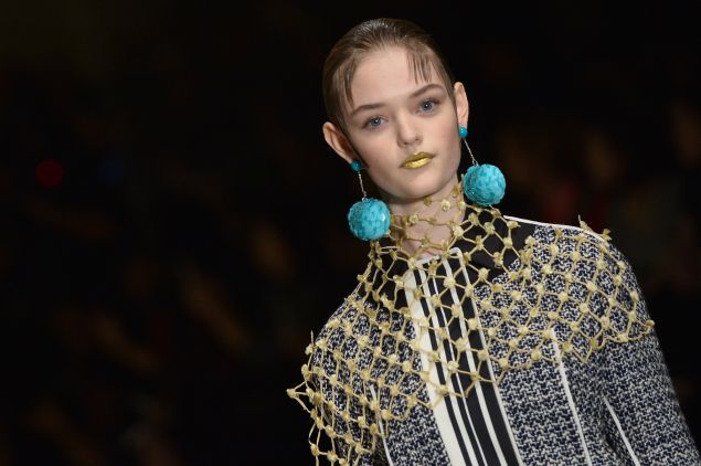 Gold lips, big earrings (Photo: Tiziana Fabi/AFP/Getty Images)