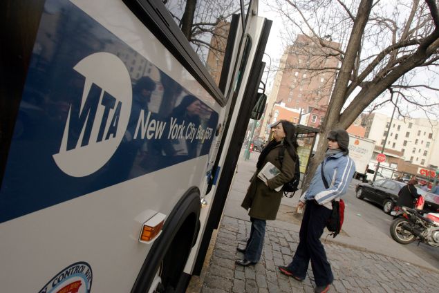 NEW YORK - DECEMBER 23: Commuters board a bus near First Avenue December 23, 2005 in New York City. After three days of strikes New York City subways and buses returned to service, bringing normality back to millions of peoples morning and afternoon commutes. (Photo by Daniel Barry/Getty Images)