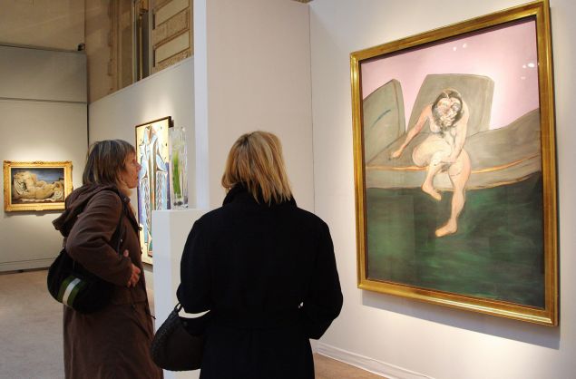 Visitors look at Francis Bacon's "Seated Woman" (Portrait of Muriel Belcher), 10 December 2007 at the Charpentier Galery in Paris. (Photo courtesy: Pierre Verdy/AFP/Getty Images)