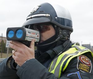 A Fairfax, Virginia, motorcycle Officer aims his ProLaser III, Lidar, towards drivers that may be speeding March 10, 2009, on Lee Highway-Route 29. AFP Photo/Paul J. Richards