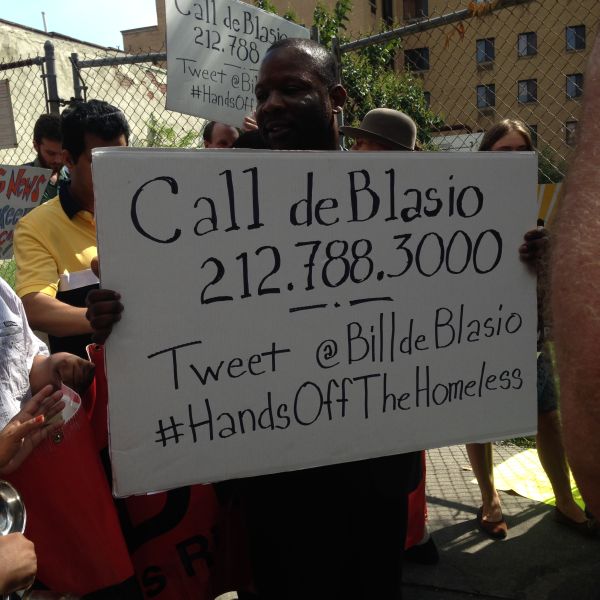 A demonstrator holds one of several signs encouraging people to lobby Mayor Bill de Blasio (Photo: Will Bredderman for Observer).