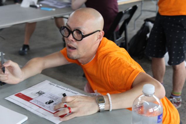 Taisan Tanaka, half of The Human Printer, lettering the name of the reporter. (Photo: Joanna Purpich, used by permission)