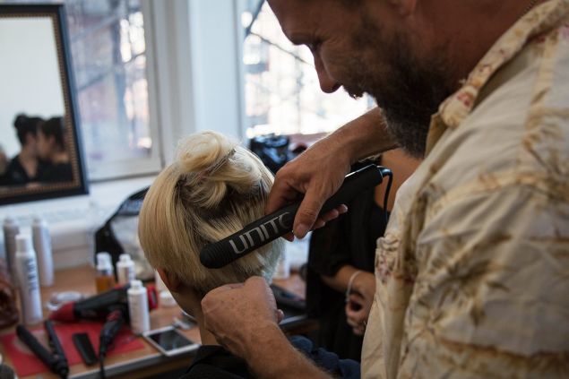 Mr. Ryan straightening a model's hair. (Photo: Observer/Kaitlyn Flannagan)