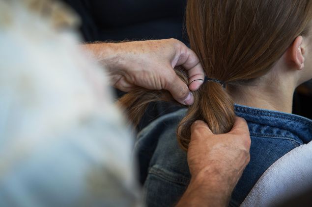 Mr. Ryan fastening a model's hair into a bun. (Photo: Observer/Kailtyn Flannagan)