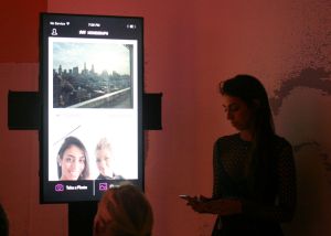 Ms. Vosough's iPhone screen shown live, using Monegraph to create rights for a photo taken on the spot. (Photo: Brady Dale for Observer)