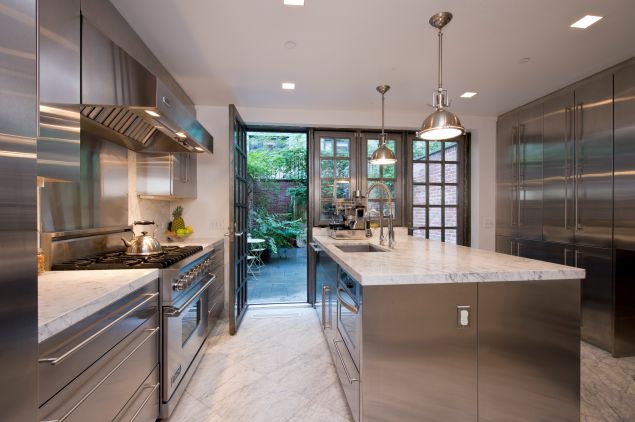 The Venturinos kitchen after the gut renovation, done in stainless steel and Carrera marble. (Juris Mardwig)