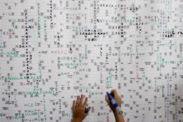 Sao Paulo, BRAZIL: A child enjoys a huge crossword puzzle made of 16.000 small squares and more than 3.200 questions as part of the launching of the 19th International Book Fair, in Sao Paulo, Brazil, 09 March 2006. Supported by The Guinness Book office in London, the crossword measuring 3,25 meters high by 1,30 meters long, has become the world's biggest. AFP PHOTO/Mauricio LIMA (Photo credit should read MAURICIO LIMA/AFP/Getty Images)