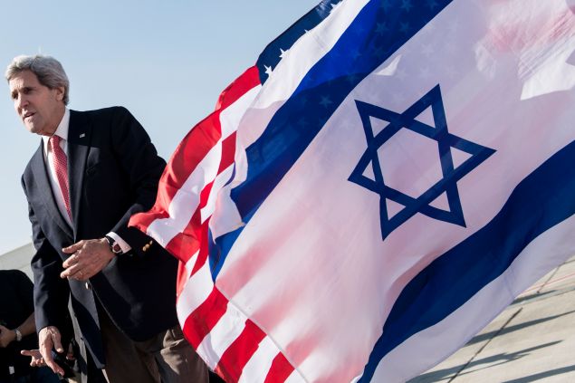 US Secretary of State John Kerry walks past American (back) and Israeli flags at Ben Gurion International Airport in Tel Aviv on January 6, 2014. Kerry is returning to the United States after four days of intense diplomacy, insisting progress has been made despite failing to agree a framework to guide Israeli-Palestinian talks. AFP PHOTO/BRENDAN SMIALOWSKI/POOL (Photo credit should read BRENDAN SMIALOWSKI/AFP/Getty Images)