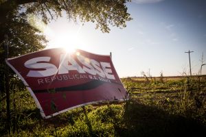 POLK, NE - OCTOBER 11: A political sign for Ben Sasse, a Republican running for U.S. Senate who supports the proposed Keystone XL pipeline, is seen directly across the street from the "Clean Energy Barn," which was built directly in the path of the proposed Keystone XL Pipeline and is equipped with solar panels and a wind turbine, on October 11, 2014 in Polk, Nebraska. The barn was built by Bold Nebraska, an organization opposed to the construction of the proposed pipeline. (Photo by Andrew Burton/Getty Images)