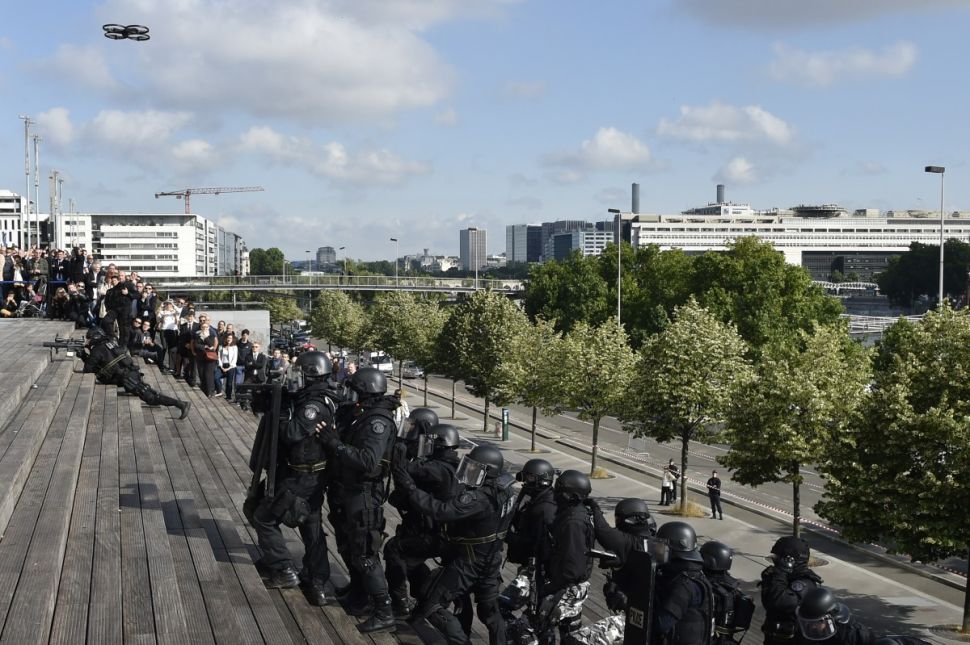 French Research and Intervention Brigades (BRI - Brigade de recherche et d'intervention) policemen officers use a drone during a training exercice at the Bibliotheque Nationale de France in Paris, on June 23, 2015 as part of the celebration of the 50th anniversary of the BRI. AFP PHOTO / DOMINIQUE FAGET (Photo credit should read DOMINIQUE FAGET/AFP/Getty Images)