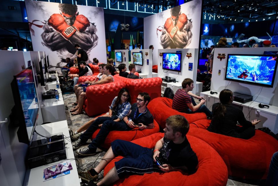 COLOGNE, GERMANY - AUGUST 05: People play video games at the Sony Playstation stand at the Gamescom 2015 gaming trade fair during the media day on August 5, 2015 in Cologne, Germany. Gamescom is the world's largest digital gaming trade fair and will be open to the public from August 6-9. (Photo by Sascha Schuermann/Getty Images)