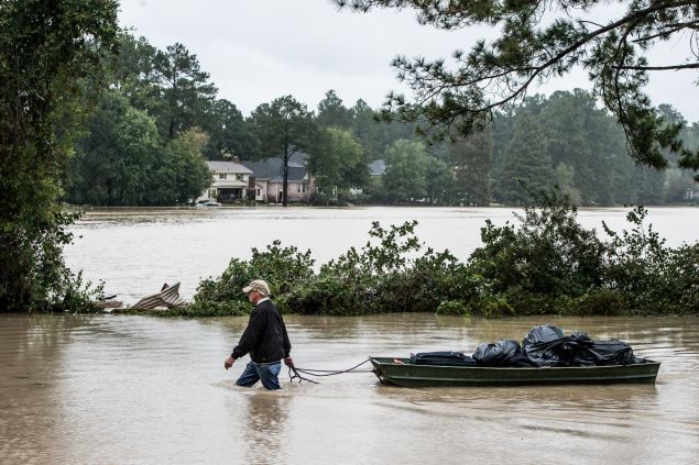 COLUMBIA, SC - OCTOBER 5: Eric Van Sant rescues possessions from a flooded home in the Forest Acres neighborhood October 5, 2015 in Columbia, South Carolina. The state of South Carolina experienced record rainfall amounts over the weekend which stranded motorists and residents and forced hundreds of evacuations and rescues. (Photo by Sean Rayford/Getty Images)