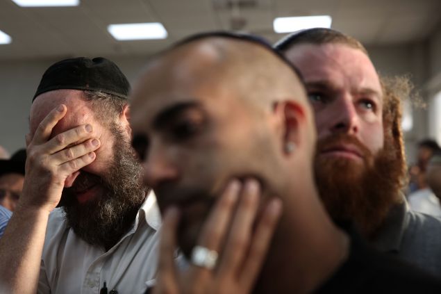 Friends and relatives mourn during the funeral of 51-year-old Israeli Alon Guverg, who was killed a day earlier when Palestinian attackers shot at a bus, in Jerusalem on October 14, 2015. The bus attack was the first assault with a gun in Jerusalem in the two-week-old upsurge of Palestinian violence. AFP PHOTO / GALI TIBBON (Photo credit should read GALI TIBBON/AFP/Getty Images)