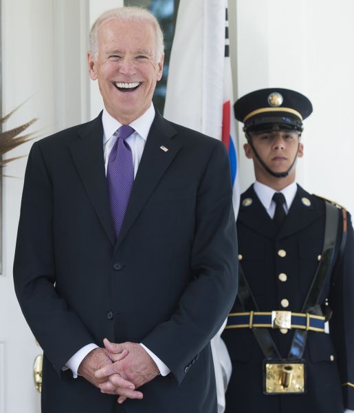 US Vice President Joe Biden laughs during the arrival of the South Korean President for lunch at the Naval Observatory in Washington, DC, October 15, 2015. AFP PHOTO / SAUL LOEB (Photo credit should read SAUL LOEB/AFP/Getty Images)