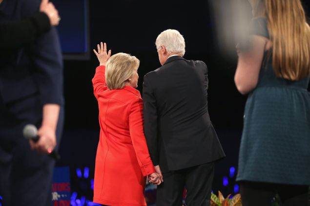 DES MOINES, IA - OCTOBER 24: Democratic presidential candidate Hillary Clinton and her husband former president Bill Clinton hold hands as they wave to guests at the end of the Jefferson-Jackson Dinner on October 24, 2015 in Des Moines, Iowa. The dinner is a major fundraiser for Iowa's Democratic Party. (Photo by Scott Olson/Getty Images)