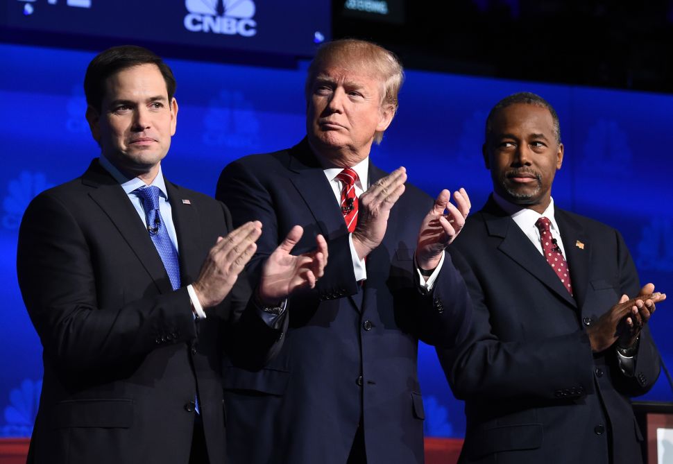 Republican presidential hopefuls (L-R) Marco Rubio, Donald Trump and Ben Carson applaud as the candidates are introduced at the start of the third Republican Presidential Debate, October 28, 2015 at the Coors Event Center at the University of Colorado in Boulder, Colorado. AFP PHOTO / ROBYN BECK (Photo credit should read ROBYN BECK/AFP/Getty Images)
