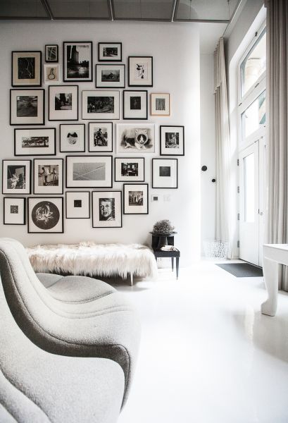 Living room with photograph wall. (Photo: Emily Assiran for Observer)