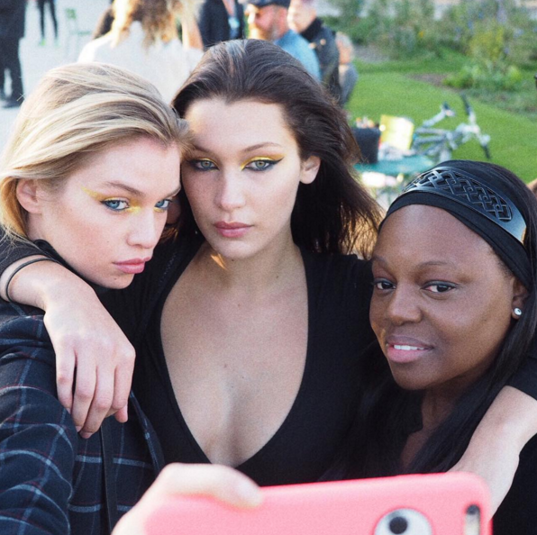 Stella Maxwell and Bella Hadid wear Gold 001, and pose with Pat McGrath (Photo: Instagram/PatMcGrathReal).