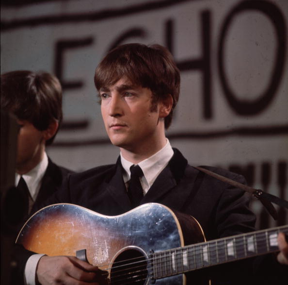 25th November 1963: John Lennon (1940 - 1980), singer, guitarist and songwriter with the Beatles, plays an acoustic guitar during Granada TV's Late Scene Extra television show filmed in Manchester, England on November 25, 1963. (Photo by Hulton Archive/Getty Images)