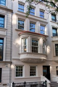 The exterior has been refinished in a limestone-based material. (Cary Horowitz/Brown Harris Stevens.)