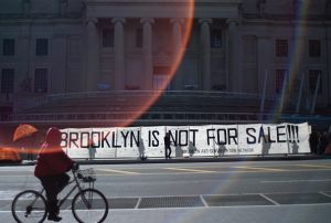 Artists and activists held signs and banners outside the Brooklyn Museum, with messages like "BK NOT 4 SALE." (Photo: Getty Images)