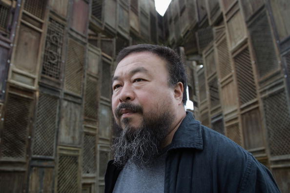 KASSEL, GERMANY - JUNE 13 Chinese Artist Ai Weiwei poses in front of his sculpture 'Template' during a media preview of Documenta 12 on June 13, 2007 in Kassel, Germany. The Documenta is "one of the most important exhibitions of modern and contemporary art" which now takes place every five years in Kassel and will be open to the public June 16 - September 23.