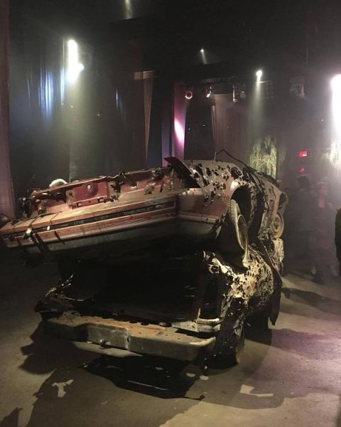 A bullet hole-ridden car featured at real estate developer's Bronx-themed rave. (KimDrew/twitter.)