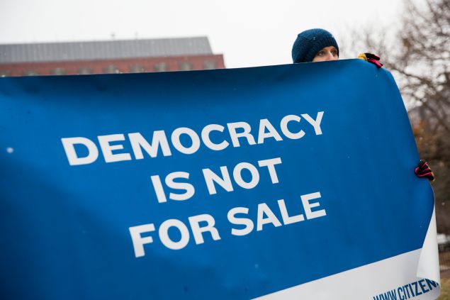 WASHINGTON, DC - JANUARY 21: An attendee holds a sign during a rally calling for an end to corporate money in politics and to mark the fifth anniversary of the Supreme Court's Citizens United decision, at Lafayette Square near the White House, January 21, 2015 in Washington, DC. Wednesday is the fifth anniversary of the landmark ruling, which paved the way for additional campaign money from corporations, unions and other interests and prevented the government from setting limits on corporate political spending. (Photo by Drew Angerer/Getty Images)
