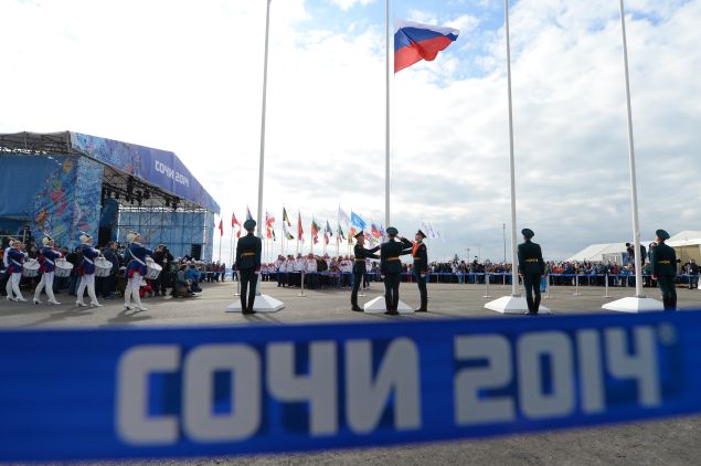 The Russian Federation's national flag (C) is hoisted during the welcoming ceremonies of the delegations ahead of the Sochi Winter Olympics, on February 5, 2014 at the Amphitheatre Square in Sochi. The opening ceremony of the Sochi Olympic Winter will take place on February 7, 2014. AFP PHOTO / ANDREJ ISAKOVIC (Photo credit should read ANDREJ ISAKOVIC/AFP/Getty Images)