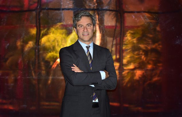 Michael Govan, Director of the Los Angeles County Museum of Art (LACMA), poses on April 28, 2015 in Los Angeles, California, in front of 'Red Concave Circle' by DeWain Valentine on exhibit at the museum for its 50th anniversary. AFP PHOTO / FREDERIC J. BROWN "MANDATORY MENTION OF THE ARTIST DEWAIN VALENTINE UPON PUBLICATION" (Photo credit should read FREDERIC J. BROWN/AFP/Getty Images)