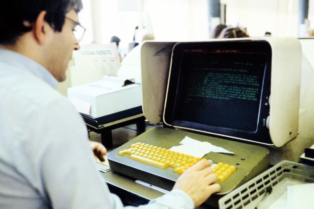 A journalist is seen working on a computer in the press room of French press agency Agence France-Presse in Paris September 1, 1981. (Photo credit should read -/AFP/Getty Images)