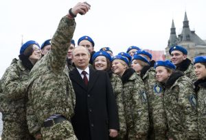 Russian President Vladimir Putin (C) poses for a selfie with young activists at the Red Square in Moscow on November 4, 2015 during celebrations for National Unity Day marking the 403rd anniversary of the 1612 expulsion of Polish occupation forces from the Kremlin. AFP PHOTO / POOL / NATALIA KOLESNIKOVA (Photo credit should read NATALIA KOLESNIKOVA/AFP/Getty Images)