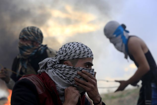Palestinian protesters are pictured during clashes with Israeli soldiers near the border fence between Israel and the central Gaza Strip east of Bureij on November 6, 2015. Israeli forces shot and killed a Palestinian in the Gaza Strip during clashes along the border, the enclave's health ministry said. AFP PHOTO / MOHAMMED ABED (Photo credit should read MOHAMMED ABED/AFP/Getty Images)