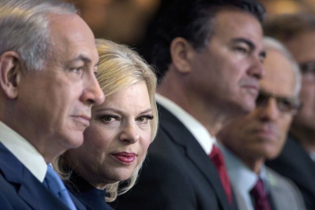 Israeli Prime Minister Benjamin Netanyahu (L) waits with his wife Sara (2L) before addressing the Jewish Federations of North America's 2015 General Assembly November 10, 2015 in Washington, DC. AFP PHOTO/BRENDAN SMIALOWSKI (Photo credit should read BRENDAN SMIALOWSKI/AFP/Getty Images)