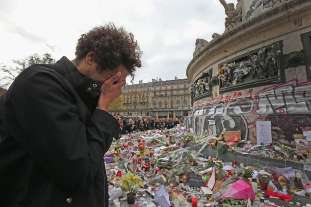 People observe a minute-silence at the Place de la Republique in memory of the victims of the Paris terror attacks last Friday, on November 16, 2015 in Paris, France. Countries across Europe will join France, currently observing three days of national mourning, in a one minute-silence today in an expression of solidarity with the victims of the terrorist attacks, which left at least 129 people dead and hundreds more injured.